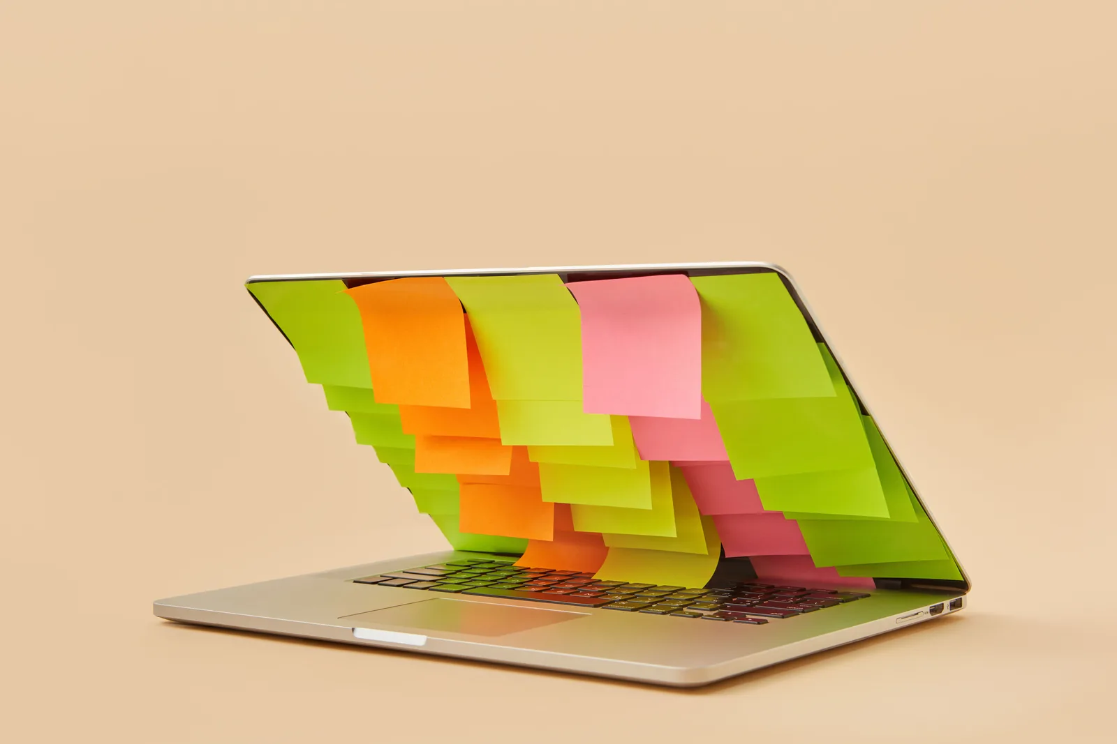 A partially closed laptop adorned with assorted colorful sticky notes on the screen. Digital customer journeys examples with the reasoning laid bare