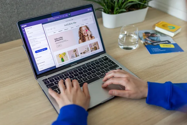 Hands typing on a laptop showing an e-commerce website in a modern office setting. Digital marketing platforms features: how to judge them