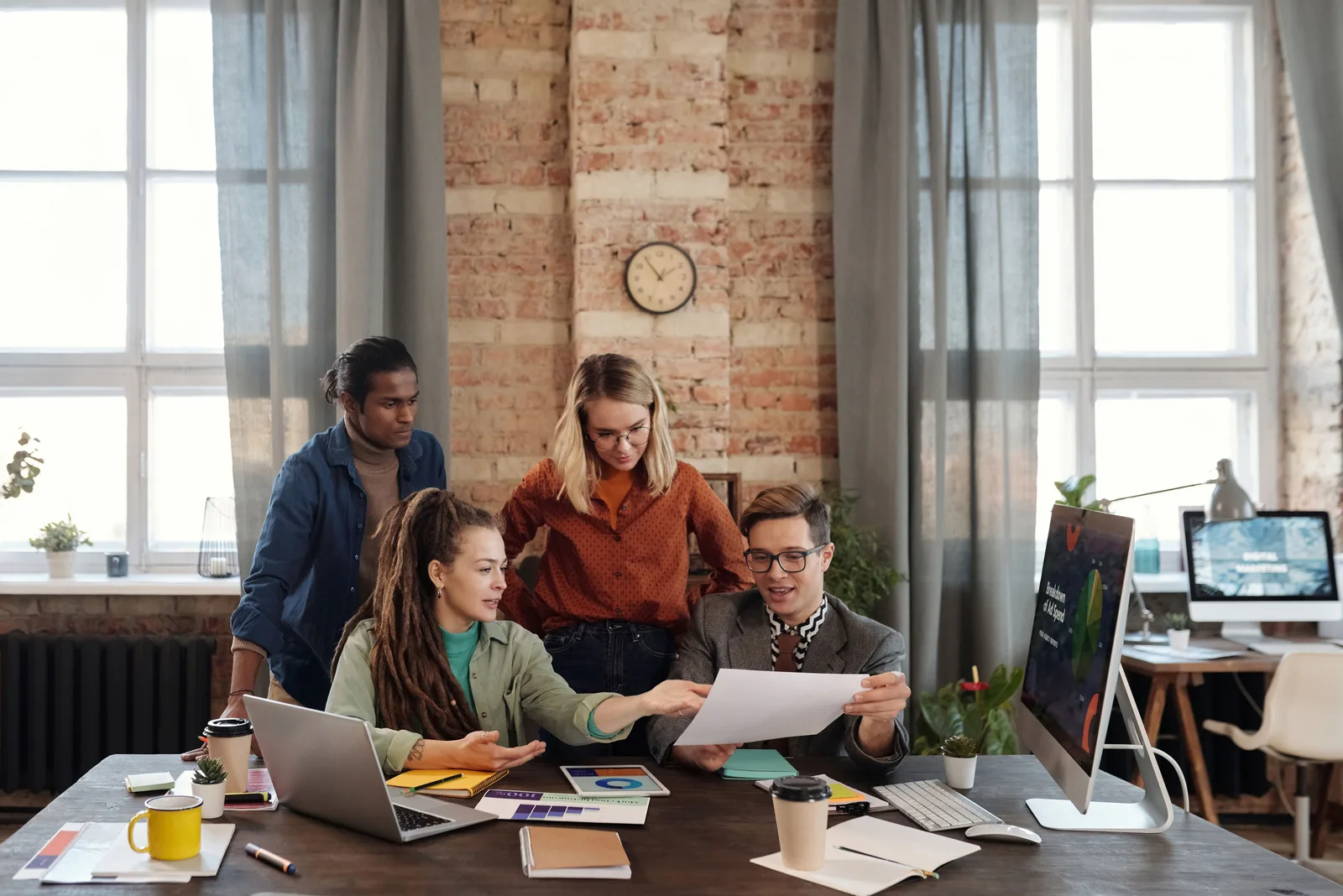 A diverse team of young professionals working on a business strategy in an urban office setting. Digital marketing strategy mistakes seen from the repair side