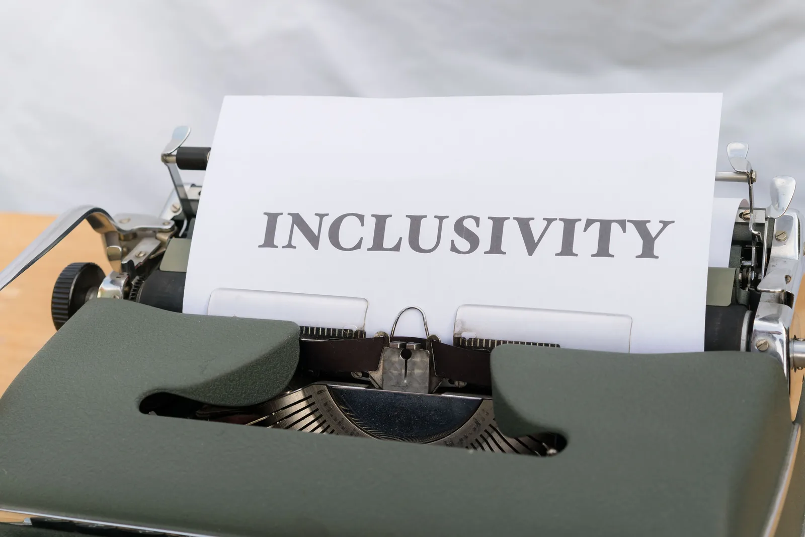 Close-up of a vintage typewriter printing the message 'INCLUSIVITY' on paper. Omnichannel digital planning under five state privacy laws